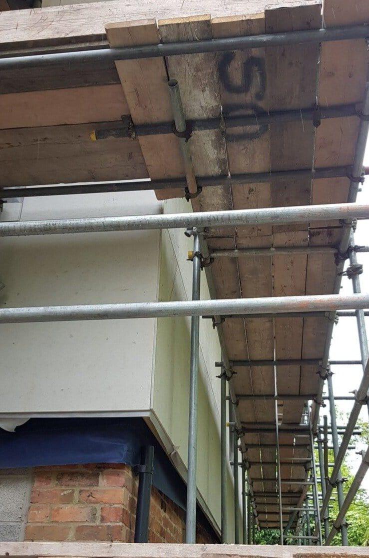 Architectural drawing of a wall-roof abutment compliant with NHBC Standards 2026 for external wall insulation